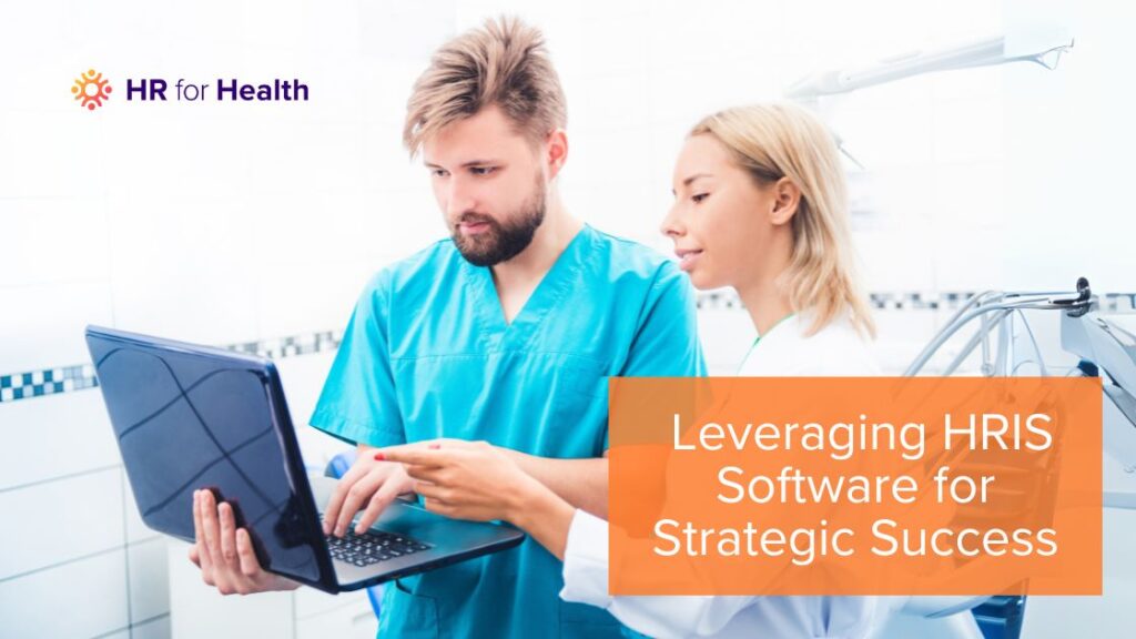 Two medical practice employees navigating an HRIS system