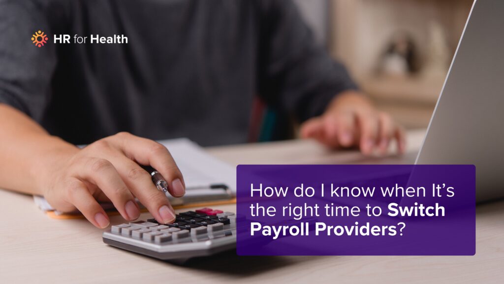 person typing on a calculator. Question: How do I know when it's the right time to switch payroll providers? HR for Health